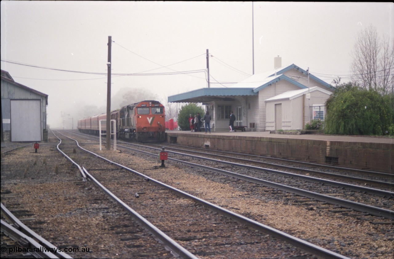 142-1-08
Euroa station overview, V/Line broad gauge N class N 457 'City of Mildura' Clyde Engineering EMD model JT22HC-2 serial 85-1225 leads an up Albury broad gauge passenger train as the station master prepares to exchange electric staffs, catch point and indicators, station building.
Keywords: N-class;N457;Clyde-Engineering-Somerton-Victoria;EMD;JT22HC-2;85-1225;