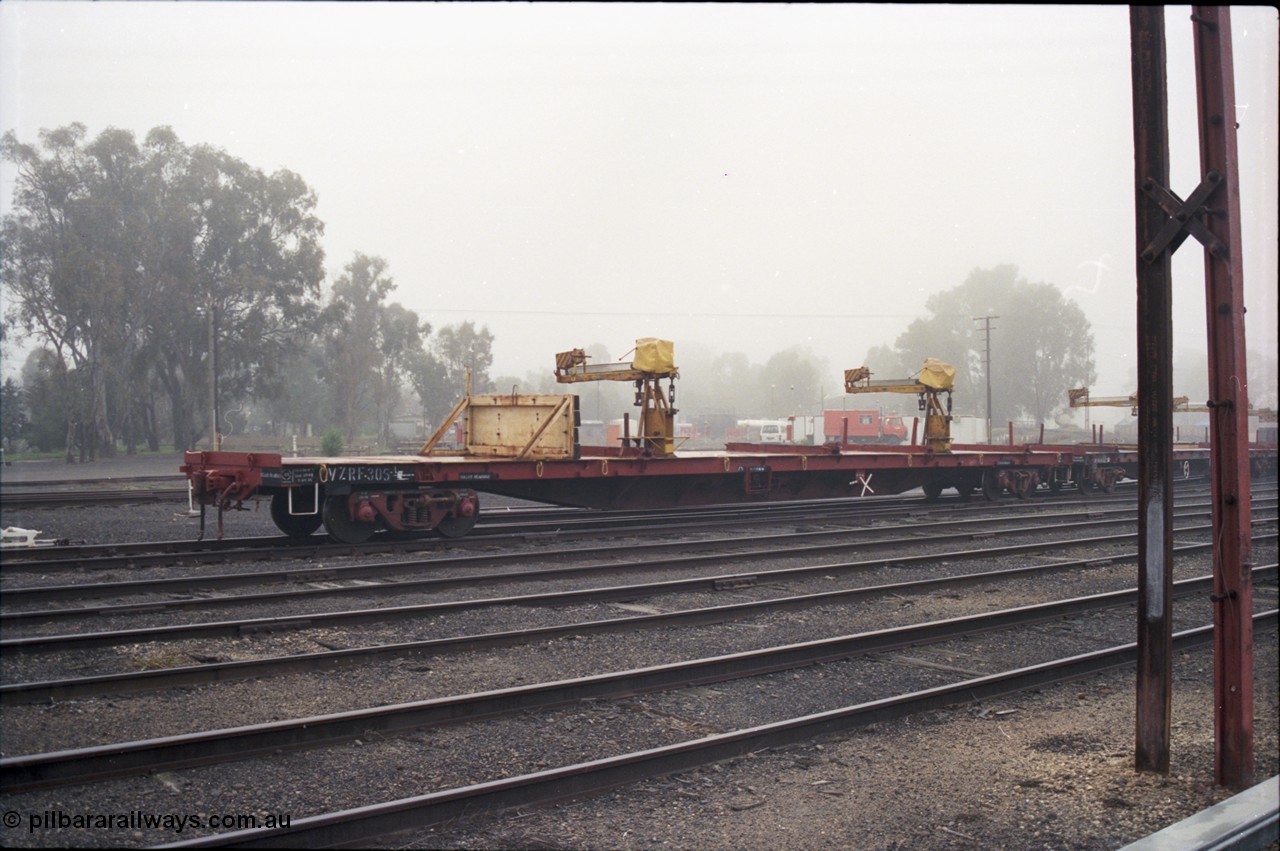 142-1-17
Benalla yard, V/Line broad gauge VZRF type bogie welded rail transport waggon VZRF 305. Built at Victorian Railways Newport Workshops in January 1970 as SKX type long bogie type flat waggon SKX 46, re-classed to SKF in 1973, then VFKW in 1981, then May 1984 converted to VFRY type VFRY 305 at Ararat.
Keywords: VZRF-type;VZRF305;Victorian-Railways-Newport-WS;SKX-type;