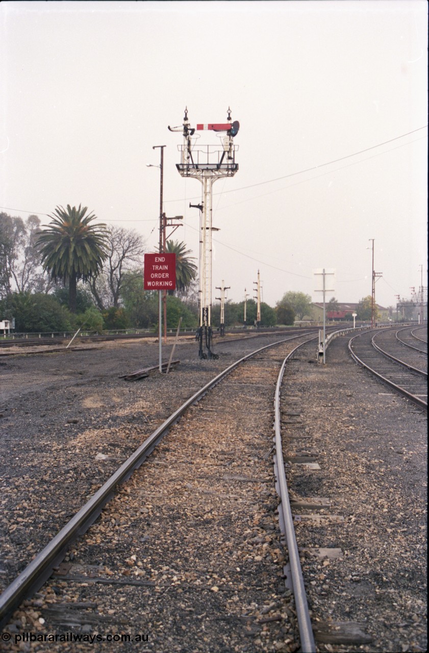 142-1-20
Benalla station yard view from Yarrawonga line, signal post 29B mostly stripped, disc signal posts 29 and 32 stripped in the background, workshops building visible is the distance, Sidings J and K visible at right.
