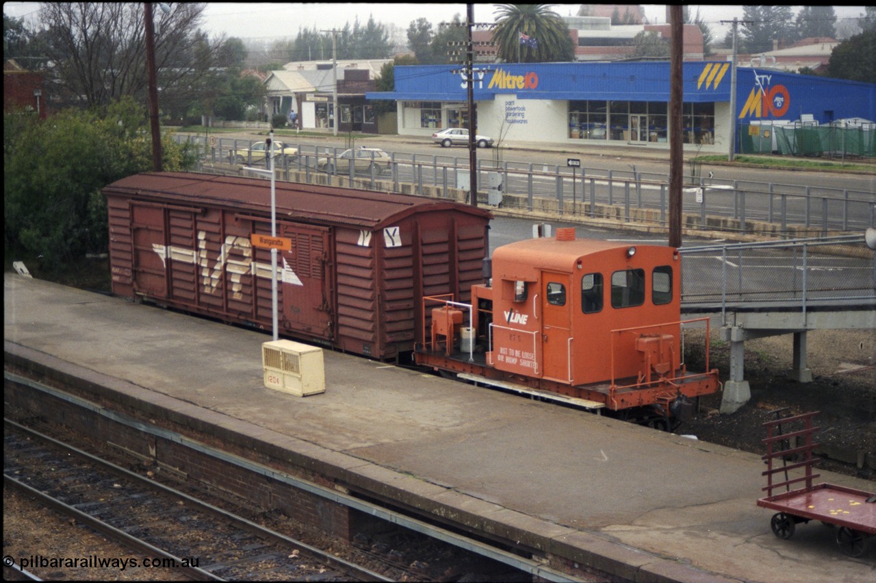 142-2-03
Wangaratta station platform and car dock road, V/Line rail tractor RT class RT 5 with VLBY type bogie louvre van VLBY 148 in VR livery, the standard gauge line is in the concrete cutting behind the RT class. RT 5 built new by Newport Workshops 06/09/1957. The VLBY which is the Wangaratta parcels waggon started out being built by Newport Workshops 30/10/1956 as a VP type VP 148, in May 1979 recoded to VLPY, recoded again in 1982 to VLBY.
Keywords: RT-class;RT5;Victorian-Railways-Newport-WS;VLBY-type;VLBY148;VP-type;VLPY-type;