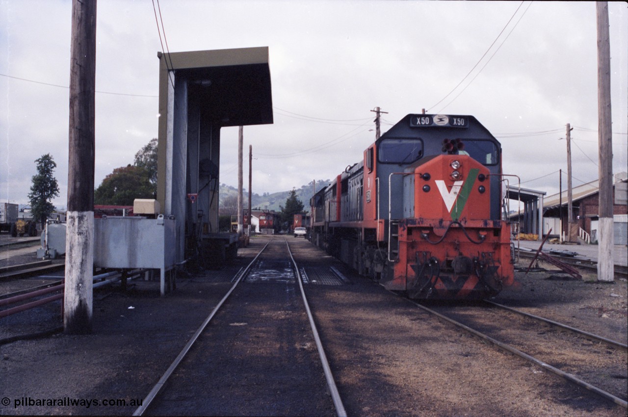 142-2-22
Wodonga loco depot fuel point, V/Line broad gauge locos lined up waiting sign on time include X class X 50 Clyde Engineering EMD model G26C serial 75-797, N class in the distance with turntable.
Keywords: X-class;X50;Clyde-Engineering-Rosewater-SA;EMD;G26C;75-797;