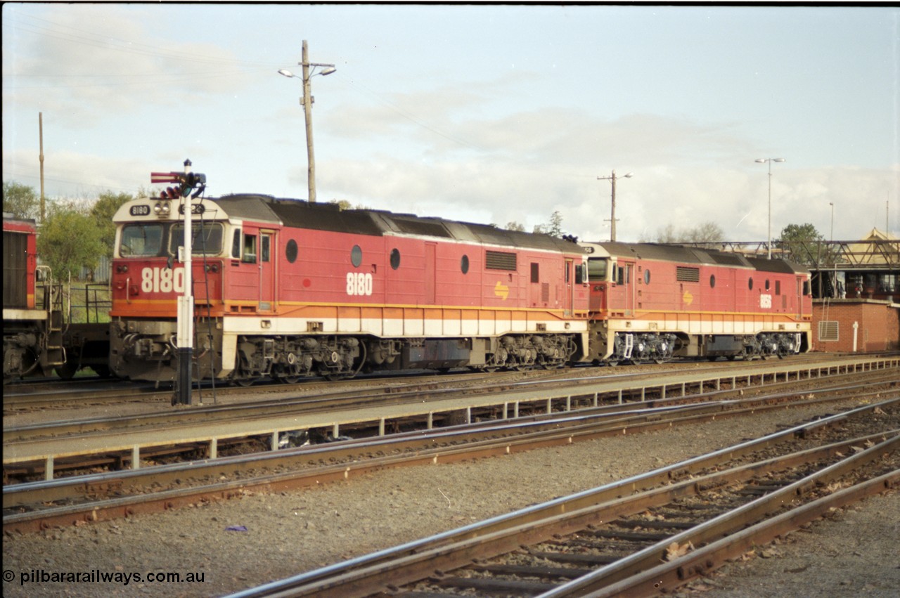 142-3-03
Albury station yard, standard gauge NSWSRA candy liveried 81 class locos 8180 Clyde Engineering EMD model JT26C-2SS serial 85-1099 and 8156 shunt light engine to the loco fuel point after running a goods down from Sydney, semaphore signal post.
Keywords: 81-class;8180;Clyde-Engineering-Kelso-NSW;EMD;JT26C-2SS;85-1099;