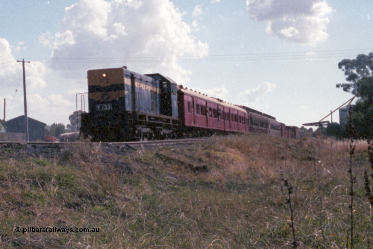 143-31
Wahgunyah, up 'Stringybark Express' mixed special powered by broad gauge VR liveried Y class Y 133 Clyde Engineering EMD model G6B serial 65-399 departs for Rutherglen, the super sheds and waggons visible to the left of the loco and the grain silos on the right, 2 BCPL class bogie passenger carriages lead the consist.
Keywords: Y-class;Y133;Clyde-Engineering-Granville-NSW;EMD;G6B;65-399;