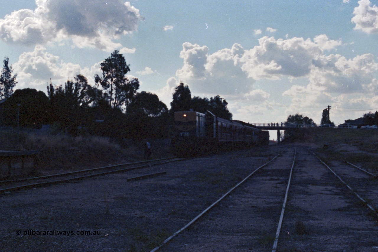 143-35
Rutherglen, up broad gauge Wahgunyah 'Stringybark Express' mixed special arrives on the mainline having just passed under the High St bridge hauled by VR liveried Y class Y 133 Clyde Engineering EMD model G6B serial 65-399 (underexposed).
