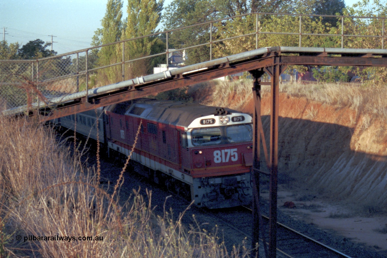 144-12
Wangaratta, standard gauge NSWSRA 81 class 8175 Clyde Engineering EMD model JT26C-2SS serial 85-1094, candy livery, leads the up Inter-Capital Daylight through the cutting and under the footbridge on the way to Melbourne.
Keywords: 81-class;8175;Clyde-Engineering-Kelso-NSW;EMD;JT26C-2SS;85-1094;
