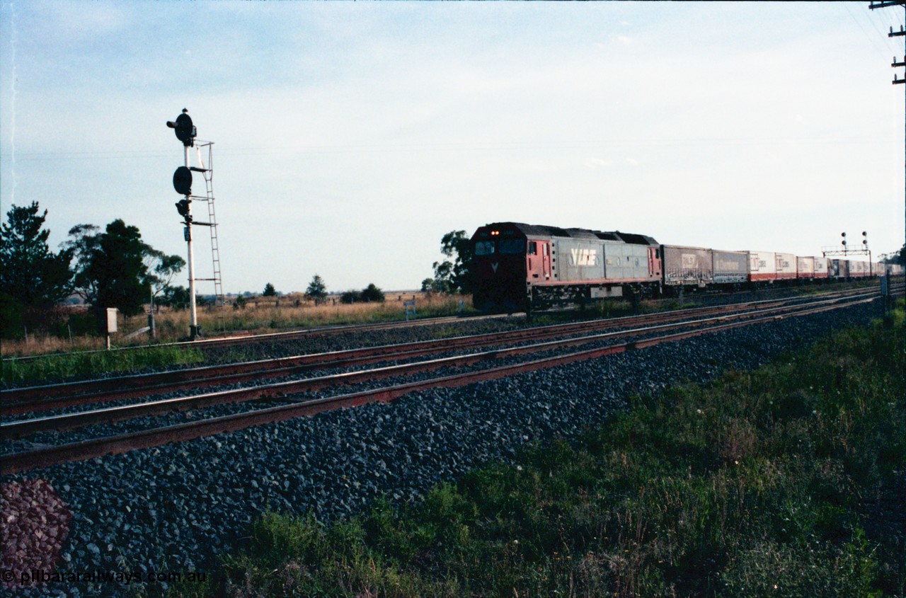 145-24
Wallan Loop, north end of standard gauge loop, broad gauge tracks in front, V/Line G class G 522 Clyde Engineering EMD model JT26C-2SS serial 86-1235 is crossing Boundary Rd with a down north bound goods.
Keywords: G-class;G522;Clyde-Engineering-Rosewater-SA;EMD;JT26C-2SS;86-1235;