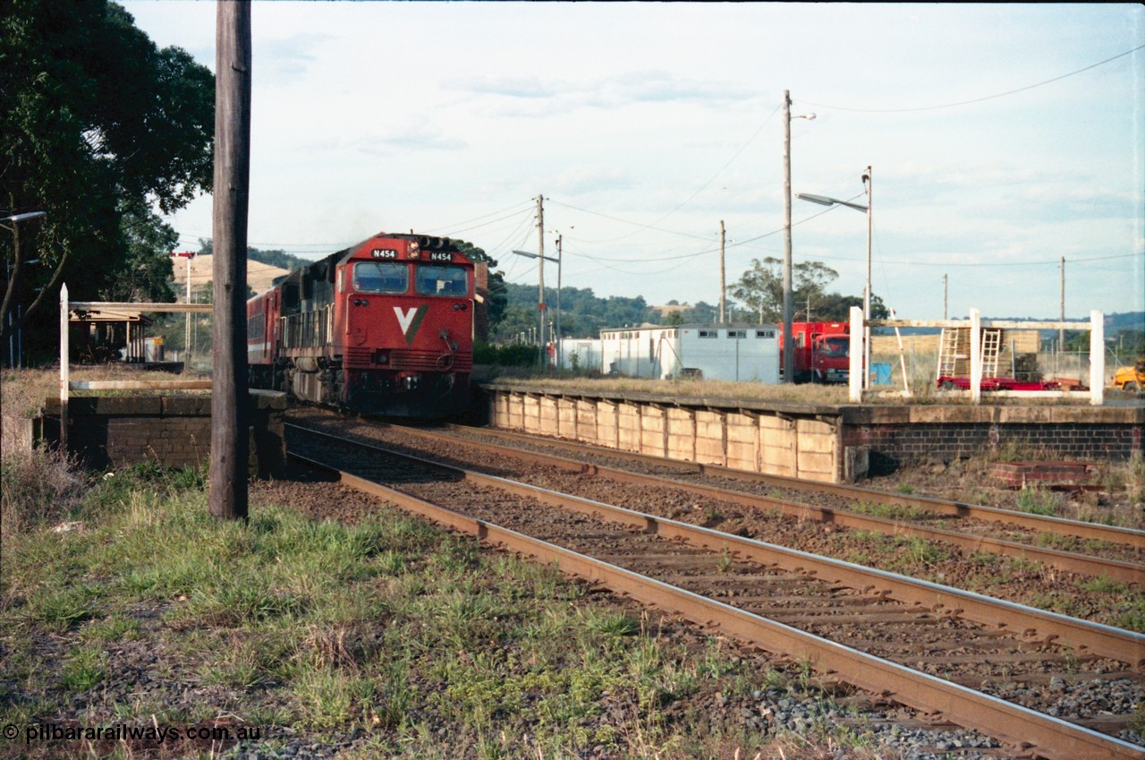 145-26
Wallan, up broad gauge passenger train under the power of V/Line N class N 454 'City of Horsham' Clyde Engineering EMD model JT22HC-2 serial 85-1222 rolls through the platform, V/Line gang camp behind platform.
Keywords: N-class;N454;Clyde-Engineering-Somerton-Victoria;EMD;JT22HC-2;85-1222;