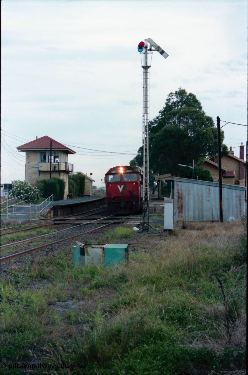 145-28
Wallan, down broad gauge Seymour passenger train hauled by V/Line N class N 455 'City of Swan Hill' Clyde Engineering EMD model JT22HC-2 serial 85-1223, gangers trolley shed at right, semaphore signal post 4 pulled off, station building behind and elevated signal box on platform two and waiting room at left.
Keywords: N-class;N455;Clyde-Engineering-Somerton-Victoria;EMD;JT22HC-2;85-1223;