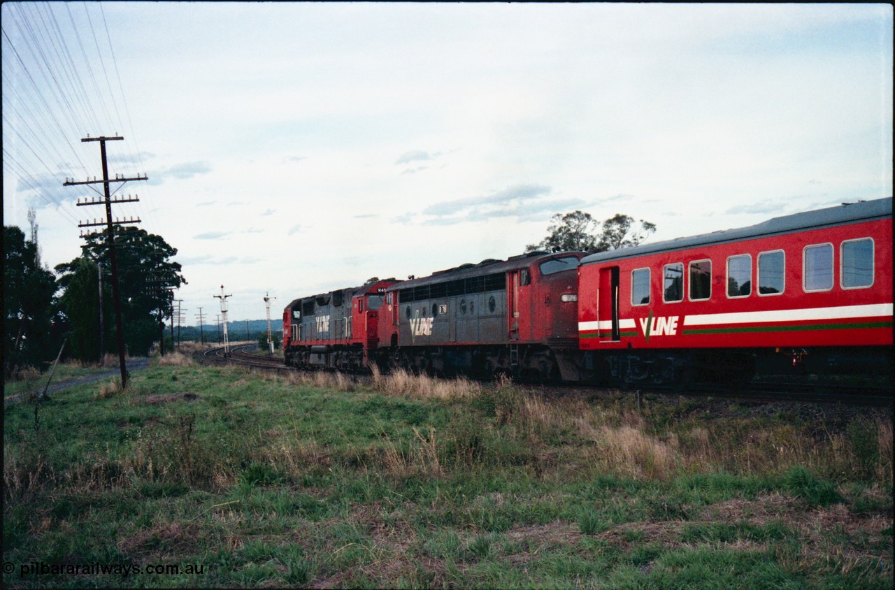 145-30
Wallan, down broad gauge Seymour pass hauled by V/Line N class N 455 'City of Swan Hill' Clyde Engineering EMD model JT22HC-2 serial 85-1223 and veteran B class B 76 Clyde Engineering EMD model ML2 serial ML2-17 with a H set, trailing view, shows discs removed off signal post 15 due to new crossover located near Boundary Rd.
Keywords: B-class;B76;Clyde-Engineering-Granville-NSW;EMD;ML2;ML2-17;bulldog;