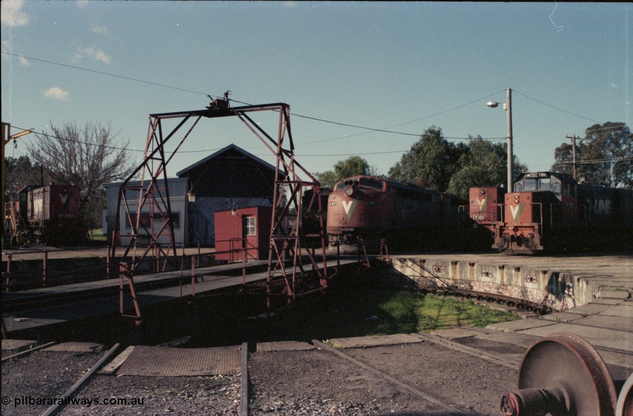 147-03
Seymour loco depot turntable overview of table and pit, broad gauge V/Line Y class Y 135 Clyde Engineering EMD model G6B serial 65-401 at left, workshop, CM parcel coach, S class S 317 ' Sir John Monash' Clyde Engineering EMD model A7 serial 61-240 and S 310 'George Higinbotham' serial 60-227, standard gauge Y class leader Y 101 serial 63-291 and broad gauge T class T 392 Clyde Engineering EMD model G8B serial 65-422.
Keywords: S-class;S317;Clyde-Engineering-Granville-NSW;EMD;A7;61-240;bulldog;