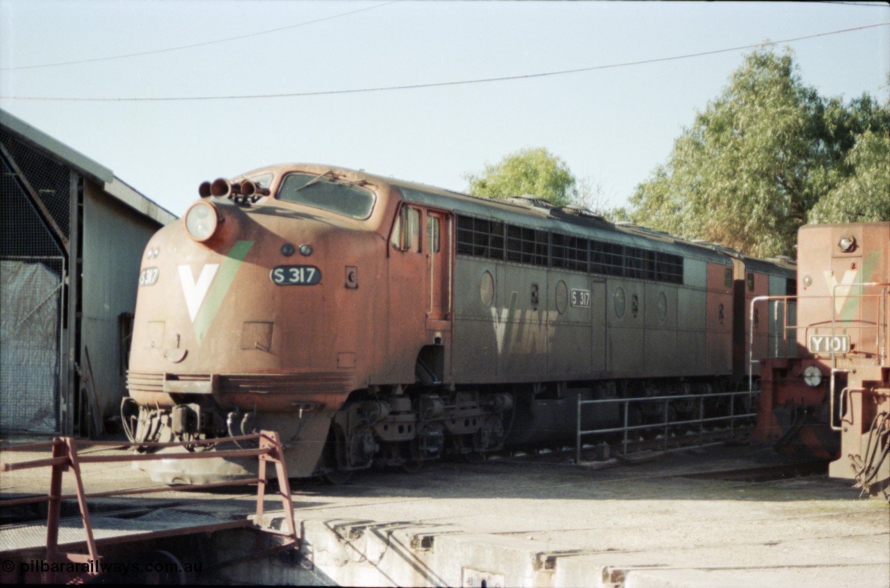 147-04
Seymour loco depot turntable roads, broad gauge V/Line S class S 317 'Sir John Monash' Clyde Engineering EMD model A7 serial 61-240 coupled to S 310 'George Higinbotham' serial 60-227 and standard gauge Y class leader Y 101 Clyde Engineering EMD model G6B serial 63-291 at right.
Keywords: S-class;S317;Clyde-Engineering-Granville-NSW;EMD;A7;61-240;bulldog;