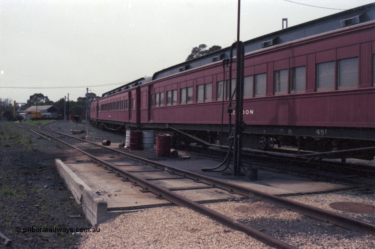 147-34
Seymour loco depot, stabled train, former Joint Stock Sleeper, No.10 Sleeper 'LODDON' at the fuel point, originally built in 1907 and called 'MELBOURNE', renamed in 1910, removed from Joint Stock in 1969 and named No. 10, then around 1984 renamed 'LODDON' in 'Train of Knowledge' service, with another Joint Stock Sleeper 'Pekina' and what looks like 'Carey'. This would no doubt be the 'Train of Knowledge'.
Keywords: E-class;Loddon;Victorian-Railways-Newport-WS;Joint-Stock;Melbourne-Sleeper;