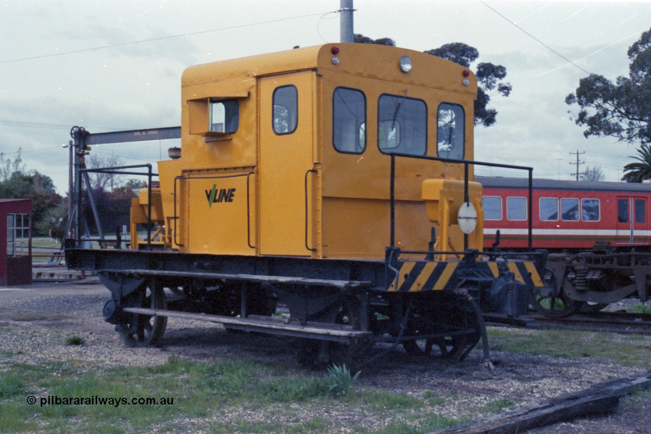 147-35
Seymour loco depot, yellow liveried V/Line rail tractor on the turn table roads, H car behind it.
