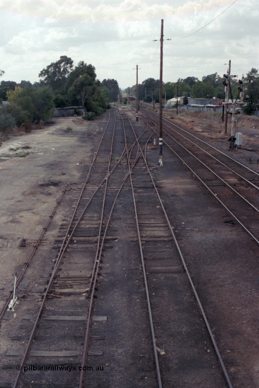 148-33
Wangaratta yard looking north (down direction) from footbridge at Nos. 5 and 4 Road extensions, point blades and K crossing for Siding J still in situ on No. 5 Road, double compound points on No. 4 Road to Siding 'C', then Main Line and Signal Post 23, standard gauge line in cutting at extreme right.
