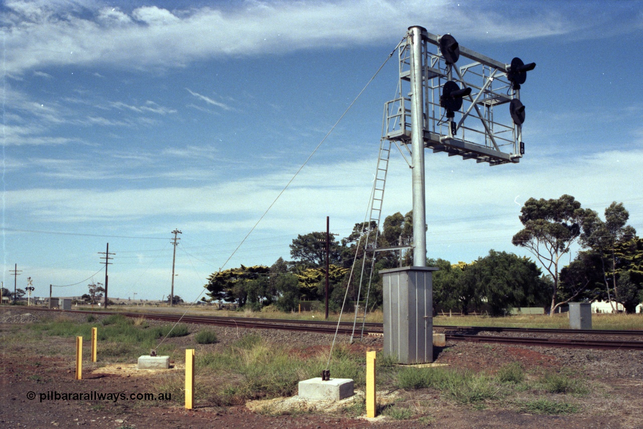 149-05
Rockbank, view of cantilevered signal post with searchlight signals 12 (No. 2 Road) and 10 (No. 1 Road) Up Home Signals, train control telephone booth and wire stays in foreground.
