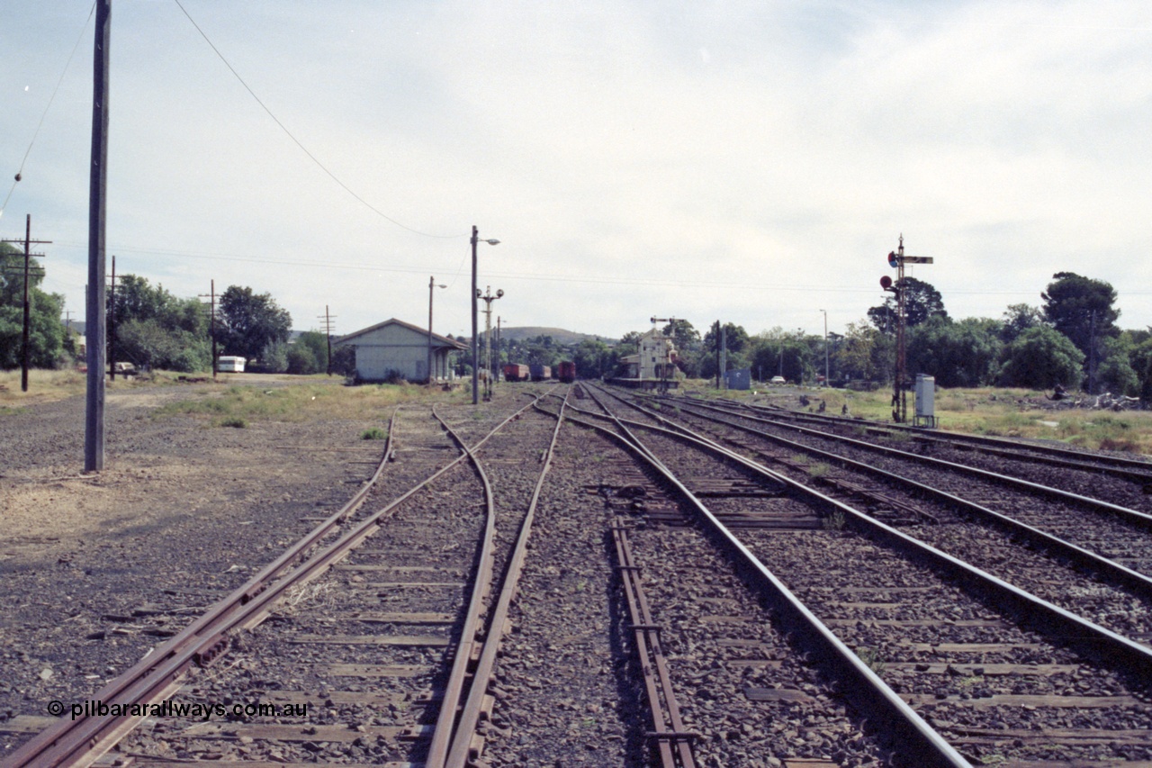 149-12
Bacchus Marsh yard overview from Melbourne end point rodding and signals, goods shed at left, stabled passenger sets, station, with road to turntable branching off to the right.
