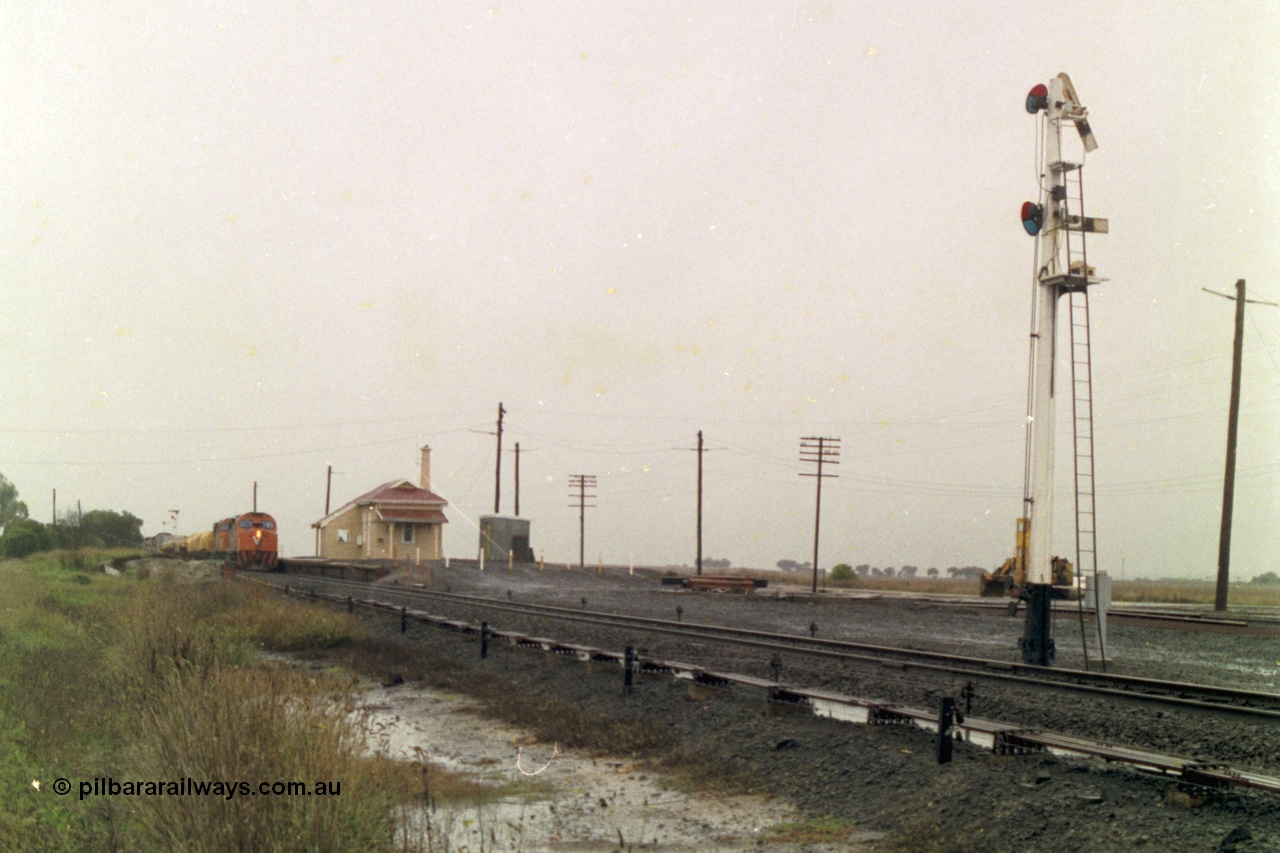 150-09
Gheringhap, station overview, point rodding and interlocking, semaphore signal post four pulled off for train 9169 to depart on the Maroona line, broad gauge V/Line C classes Clyde Engineering EMD model GT26C on the lead.
