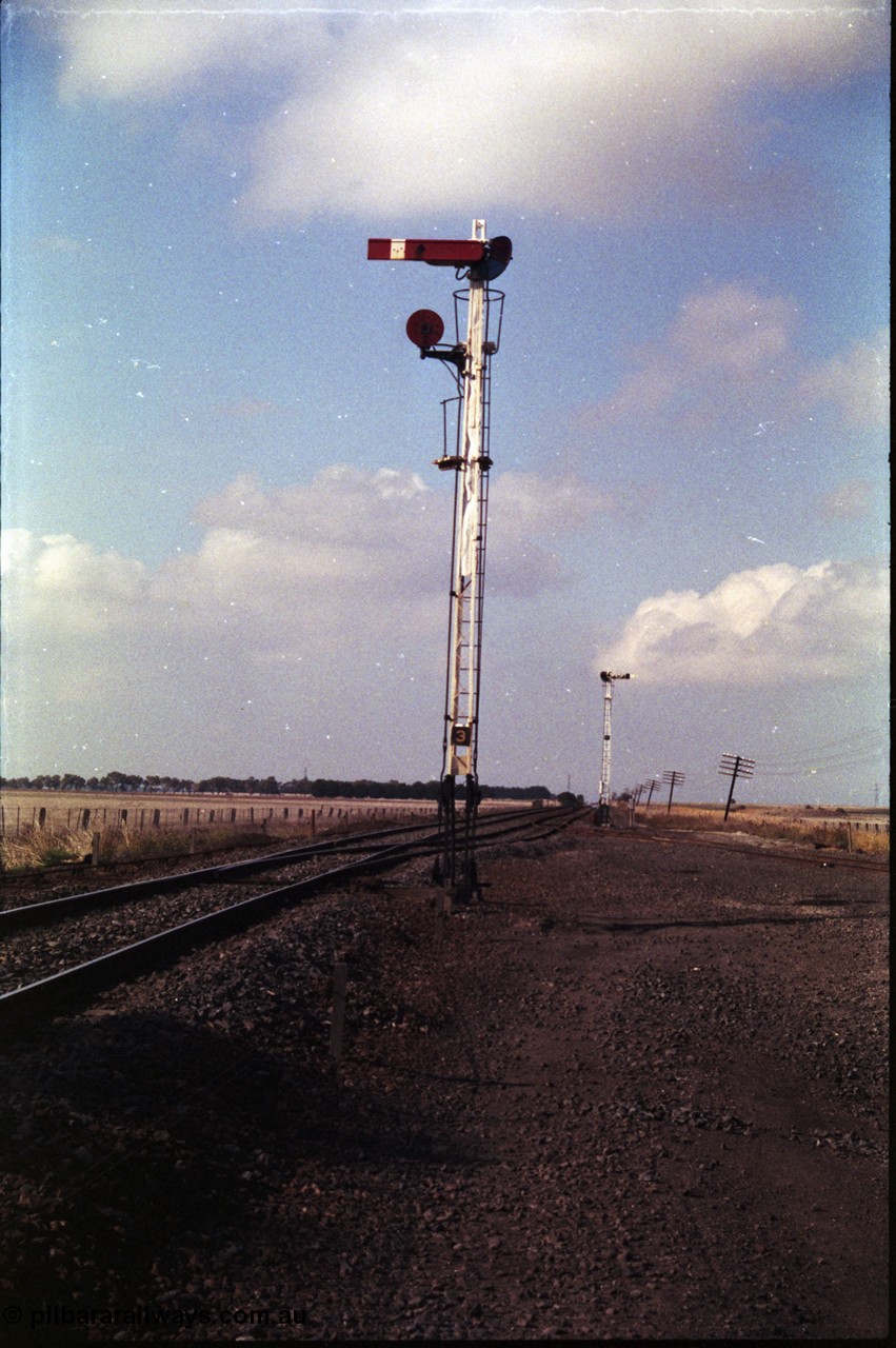 151-08
Gheringhap semaphore signal post three, up home for No.1 Road, semaphore for the mainline, disc for A Siding, semaphore signal post two visible, track to the right is B Sidings.
