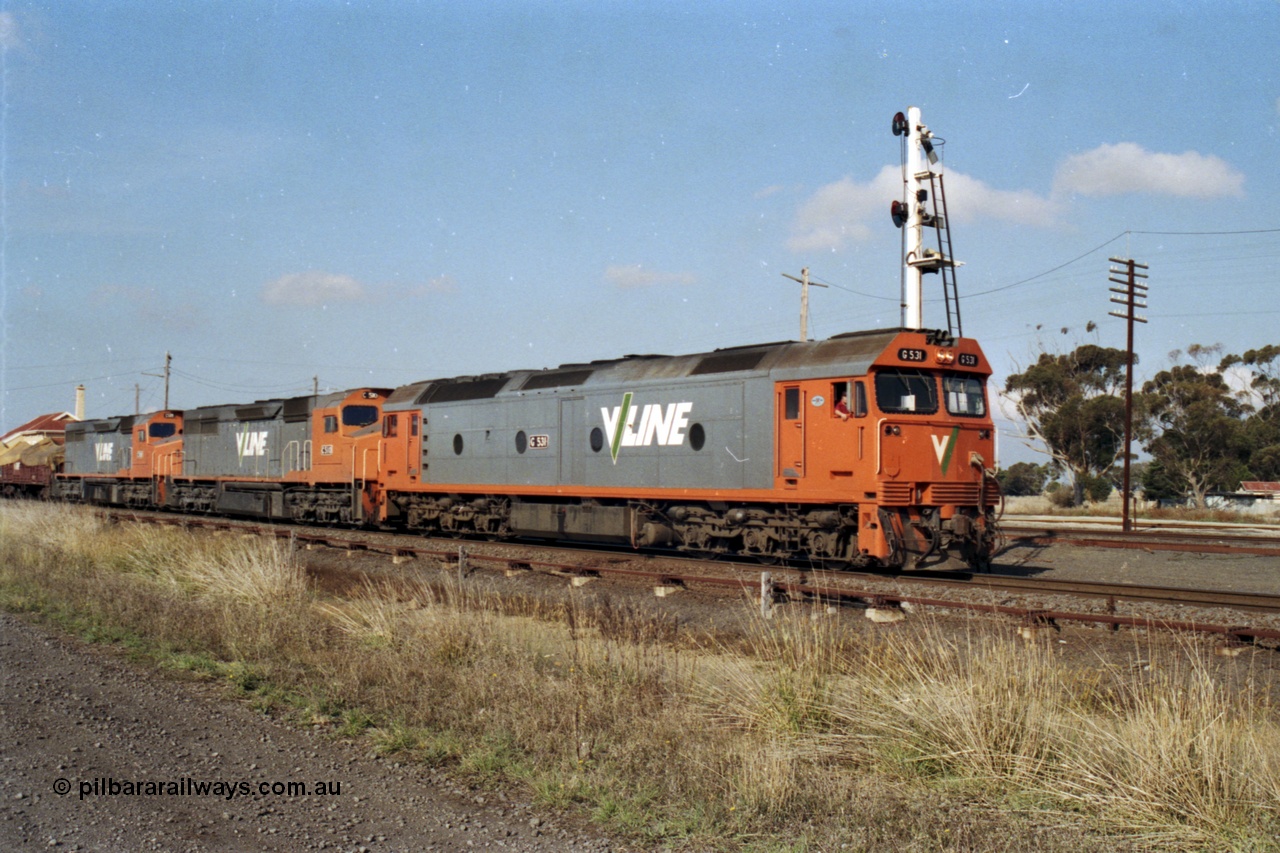 151-16
Gheringhap, broad gauge V/Line Adelaide bound goods train 9169 on No.1 Road under the power of G class G 531 Clyde Engineering EMD model JT26C-2SS serial 88-1261, C class C 510 Clyde Engineering EMD model GT26C serial 76-833 and C 509 serial 76-832 depart with signal post four set for the Maroona line, point rodding and signal wires in foreground.
Keywords: G-class;G531;Clyde-Engineering-Somerton-Victoria;EMD;JT26C-2SS;88-1261;