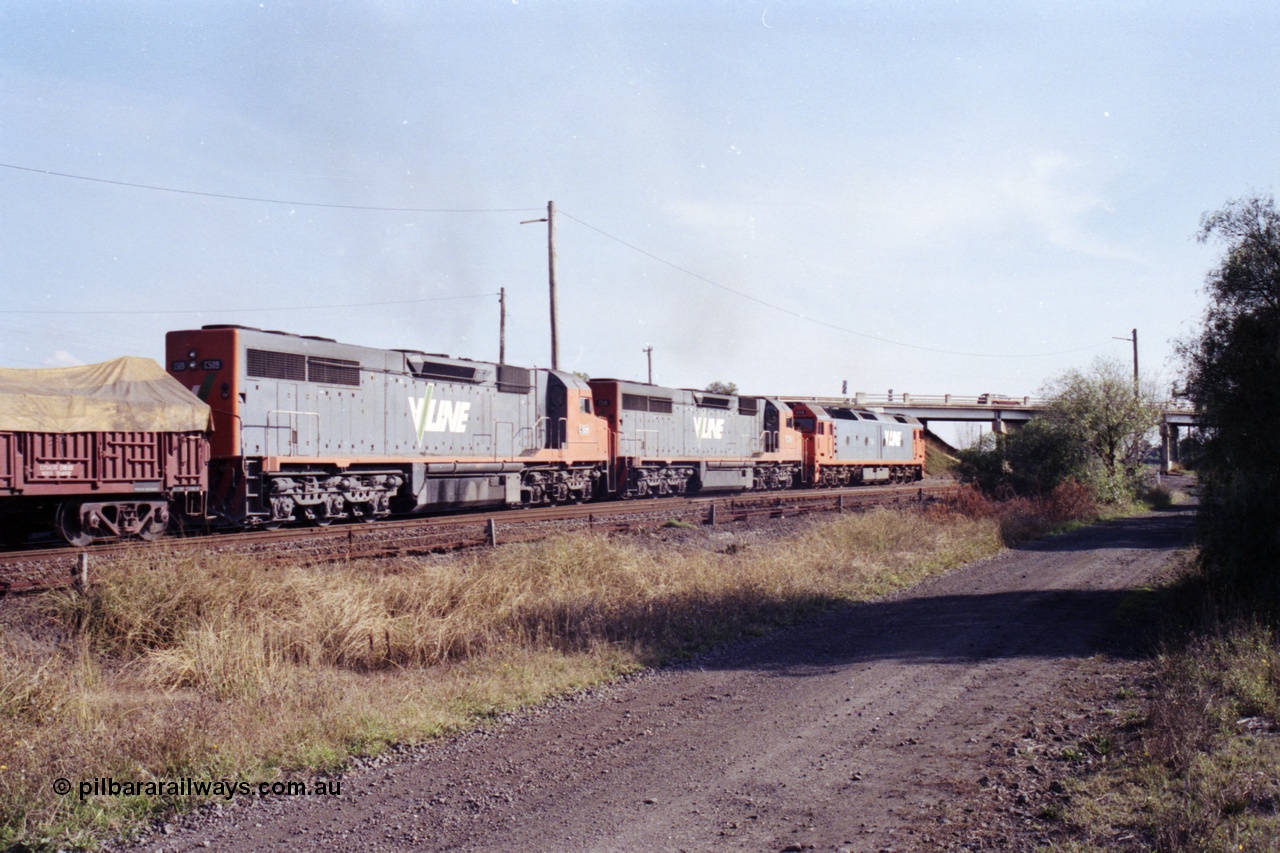 151-17
Gheringhap, broad gauge V/Line Adelaide bound goods train 9169 on No.1 Road under the power of G class G 531 Clyde Engineering EMD model JT26C-2SS serial 88-1261, C class C 510 Clyde Engineering EMD model GT26C serial 76-833 and C 509 serial 76-832 on the Maroona line, point rodding and signal wires in foreground, trailing view.
Keywords: C-class;C509;Clyde-Engineering-Rosewater-SA;EMD;GT26C;76-832;