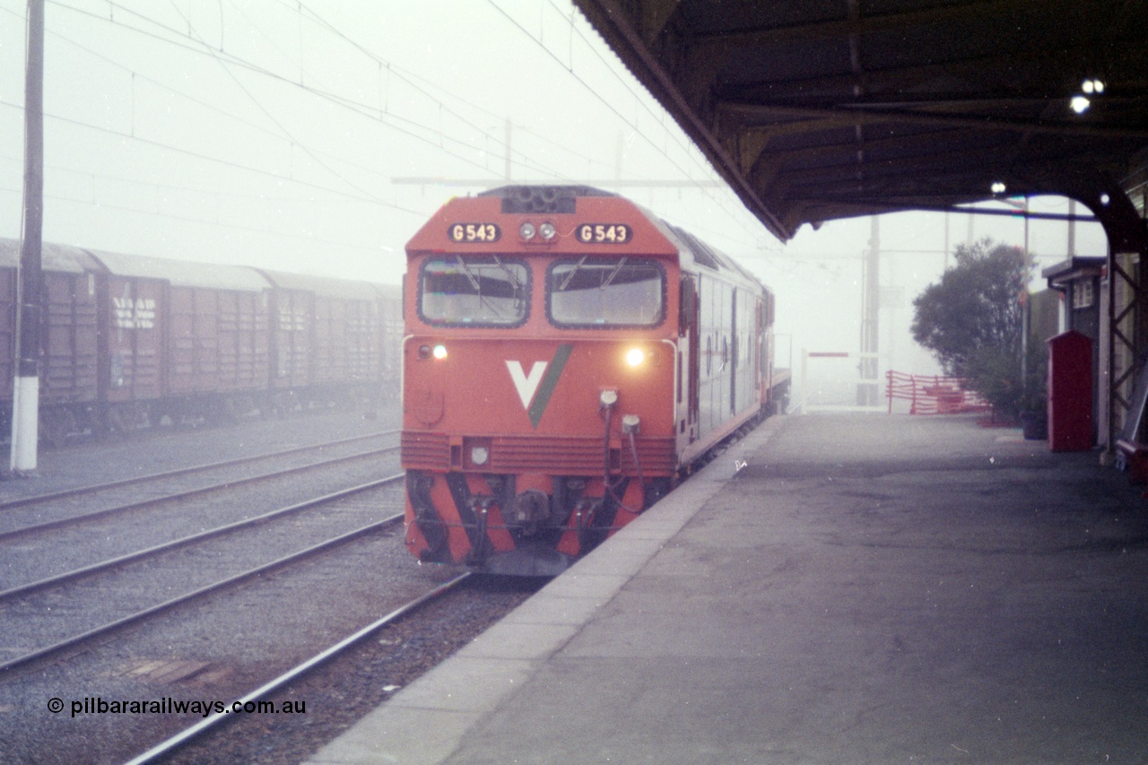 151-20
Traralgon station platform, V/Line broad gauge G class G 543 Clyde Engineering EMD model JT26C-2SS serial 89-1276 light engine with an X class awaits departure time on 9444 light engine to Morwell and then loaded briquette train to Nth Geelong in heavy fog.
Keywords: G-class;G543;Clyde-Engineering-Somerton-Victoria;EMD;JT26C-2SS;89-1276;