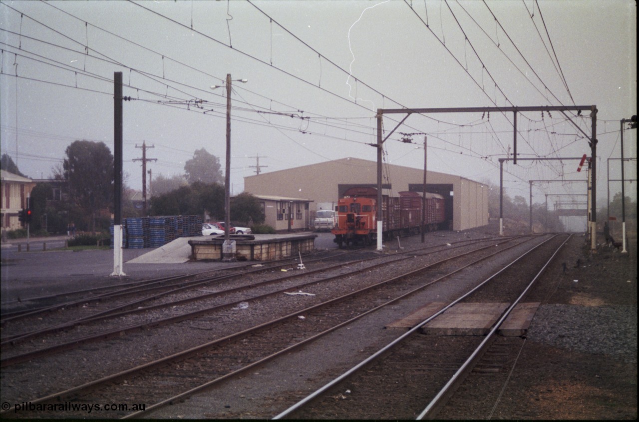 152-05
Morwell yard view looking towards Melbourne, signal post seven pulled off for up passenger train, V/Line rail tractor RT class RT 51 at the Freightgate goods shed with various louvre van, loading platform. RT 51 was converted in 1959 from the underframe of I type I 7257 built in September 1904, in 1935 recoded IA.
