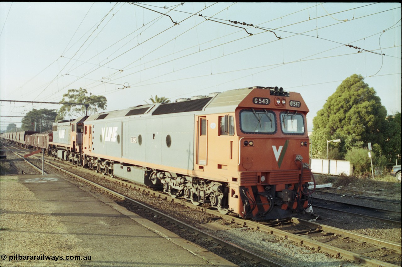 152-09
Morwell station yard, V/Line broad gauge train 9444 goods to Nth Geelong arrives into the yard from the briquette sidings behind G class G 543 Clyde Engineering EMD model JT26C-2SS serial 89-1276 and X class X 43 Clyde Engineering EMD model G26C serial 70-706, taken from station platform.
Keywords: G-class;G543;Clyde-Engineering-Somerton-Victoria;EMD;JT26C-2SS;89-1276;