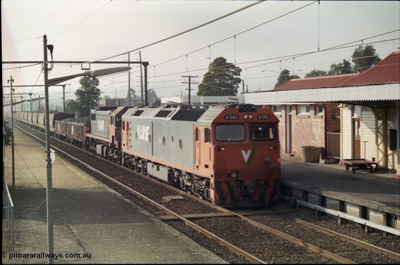 152-10
Trafalgar station, V/Line broad gauge train 9444 goods to Nth Geelong behind G class G 543 Clyde Engineering EMD model JT26C-2SS serial 89-1276 and X class X 43 Clyde Engineering EMD model G26C serial 70-706, rolls through the up platform, taken from the down station platform.
Keywords: G-class;G543;Clyde-Engineering-Somerton-Victoria;EMD;JT26C-2SS;89-1276;