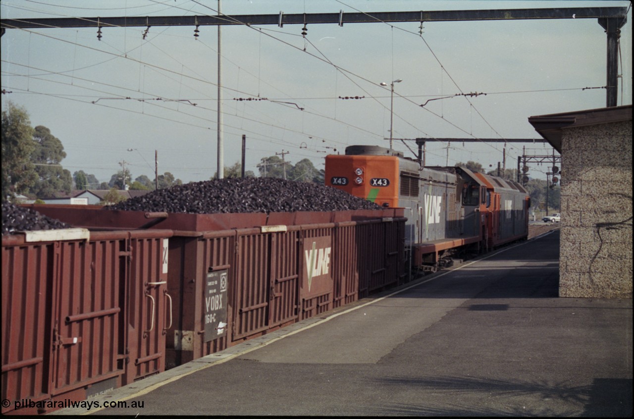 152-13
Pakenham station, V/Line broad gauge up 9444 goods to Nth Geelong with G class G 543 Clyde Engineering EMD model JT26C-2SS serial 89-1276 and X class X 43 Clyde Engineering EMD model G26C serial 70-706 and VOBX class bogie briquette waggon VOBX 160.
