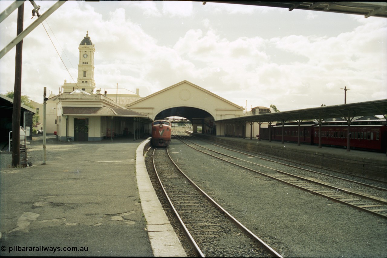 153-1-12
Ballarat station building, platform and yard overview looking from the east end of the platform and through canopy, broad gauge V/Line A class A 79 Clyde Engineering EMD model AAT22C-2R serial 84-1188 rebuilt from B 79 Clyde Engineering EMD model ML2 serial ML2-20 at platform.
Keywords: A-class;A79;Clyde-Engineering-Rosewater-SA;EMD;AAT22C-2R;84-1188;rebuild;bulldog;