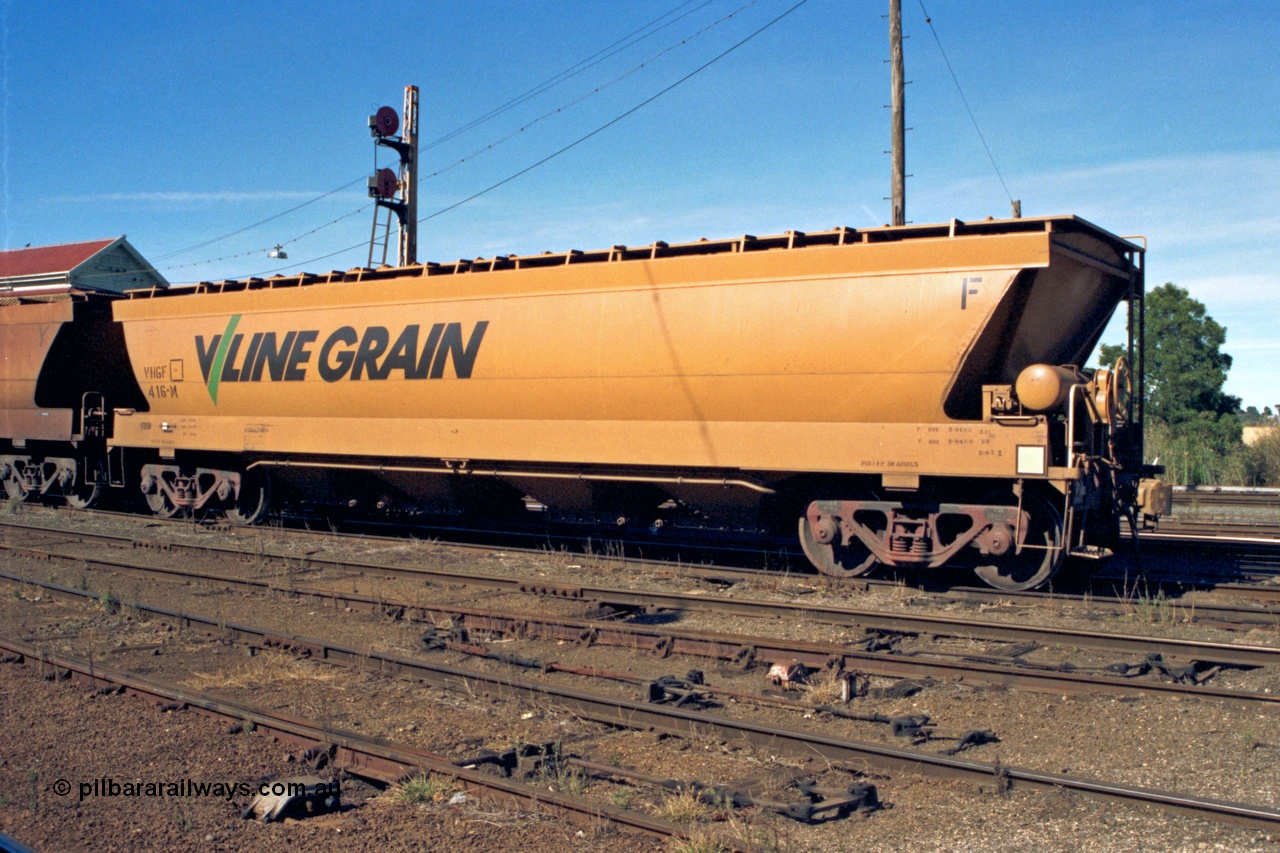 153-2-15
Ballarat station yard, broad gauge V/Line Grain VHGF type bogie grain hopper waggon VHGF 416 originally built by V/Line's Ballarat North Workshops in November 1984 as VHGY type and recoded in 1988 to VHGF, view from handbrake end, double disc signal mast behind, catch point interlocking and rodding in foreground.
Keywords: VHGF-type;VHGF416;V/Line-Ballarat-Nth-WS;VHGY-type;