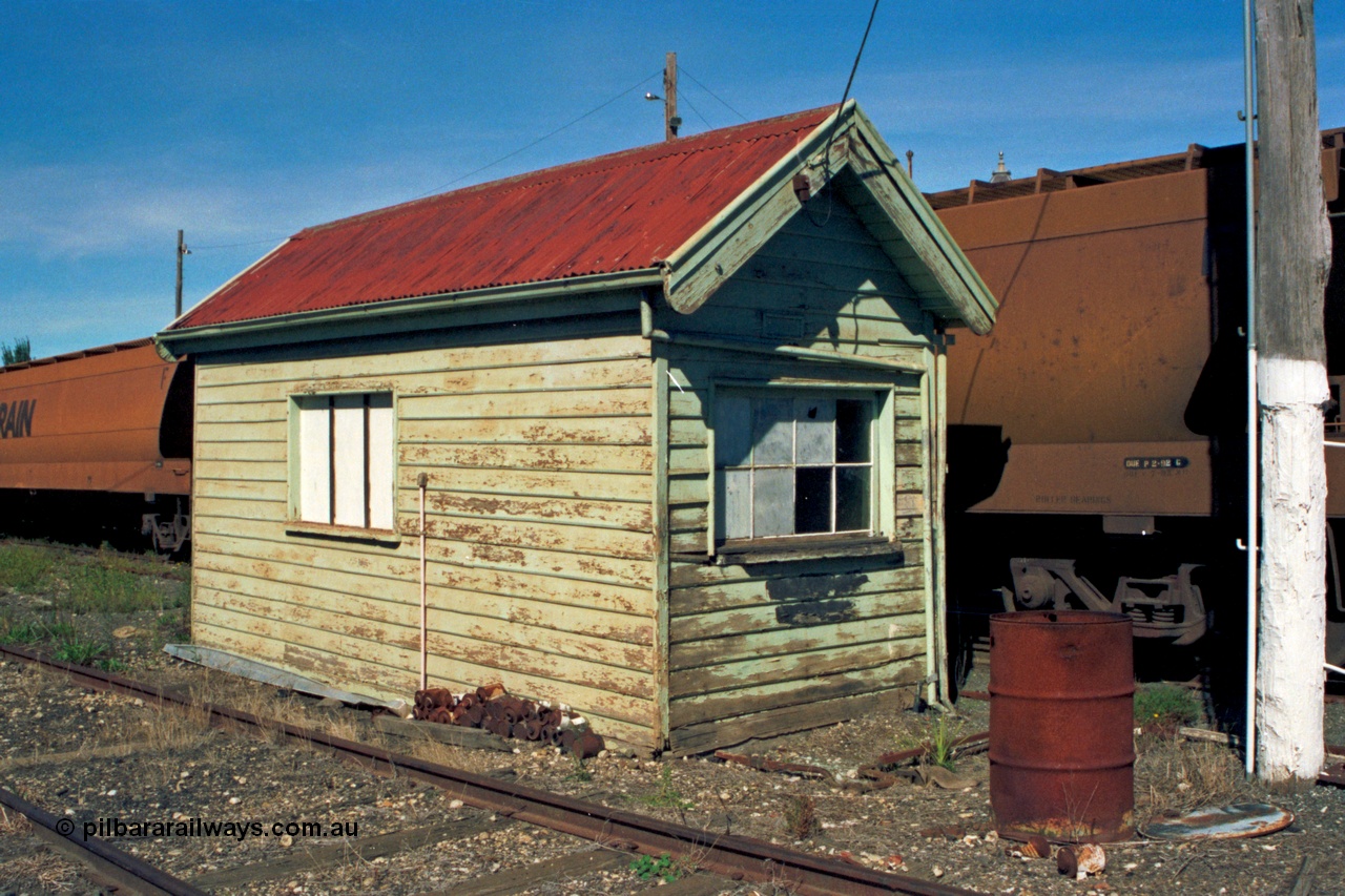 153-2-18
Ballarat station yard, weighbridge scale hut, point rodding out of hut is for selecting the points at each end of the weighbridge for either the fixed track or weigh track, V/Line bogie grain waggons.
