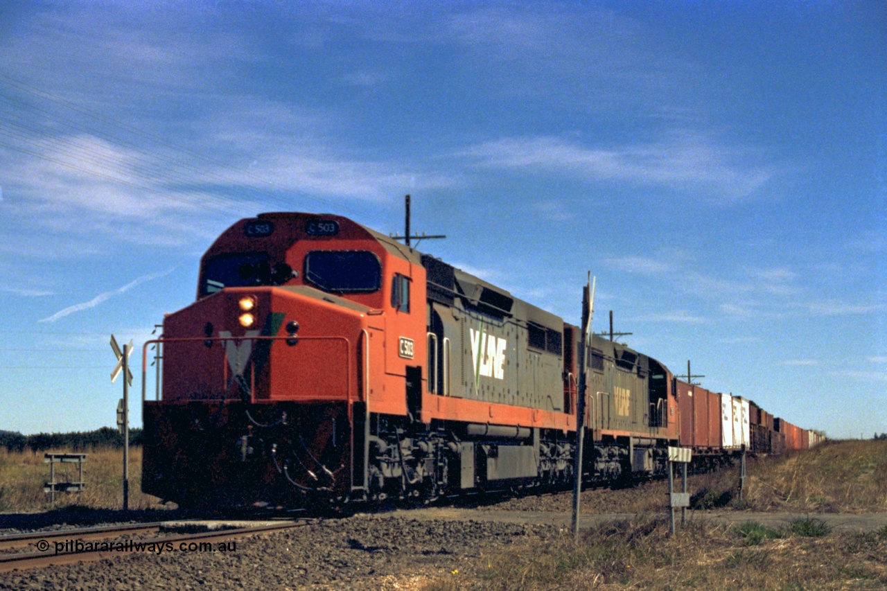 153-2-21
Trawalla, V/Line broad gauge up goods train with double C class locos C 503 Clyde Engineering EMD model GT26C serial 76-826 and a sister with train 9150 at Smiths Rd crossing.
Keywords: C-class;C503;Clyde-Engineering-Rosewater-SA;EMD;GT26C;76-826;