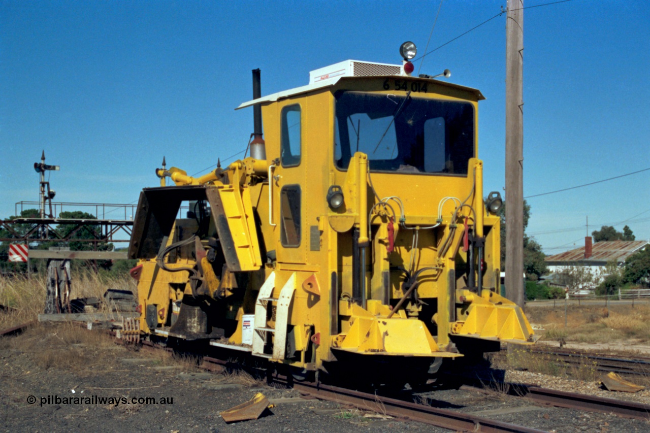153-2-36
Ararat station yard, ballast regulator, signal gantry for mainline behind in background.

