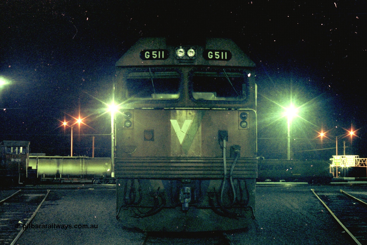 153-3-29
Geelong loco depot, stabled V/Line broad gauge locomotive and class leader G class G 511 Clyde Engineering EMD model JT26C-2SS serial 84-1239, cab front, night shot.
Keywords: G-class;G511;Clyde-Engineering-Rosewater-SA;EMD;JT26C-2SS;84-1239;