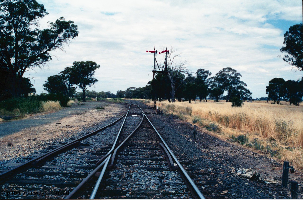 156-24
Numurkah, Picola Junction looking north from the end of Numurkah yard, line to Strathmerton is straight, Picola line branches off to the left, double doll semaphore signal post pulled off for Strathmerton line.
