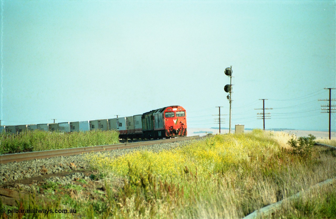 159-04
Bank Box Loop, distant view of a down Adelaide bound broad gauge goods train rounding the curve with the super elevation of the mainline visible being hauled by V/Line G class G 540 Clyde Engineering EMD model JT26C-2SS serial 89-1273 and Australian National 700 class 704 AE Goodwin ALCo model DL500G serial G6059-2.
Keywords: G-class;G540;Clyde-Engineering-Somerton-Victoria;EMD;JT26C-2SS;89-1273;