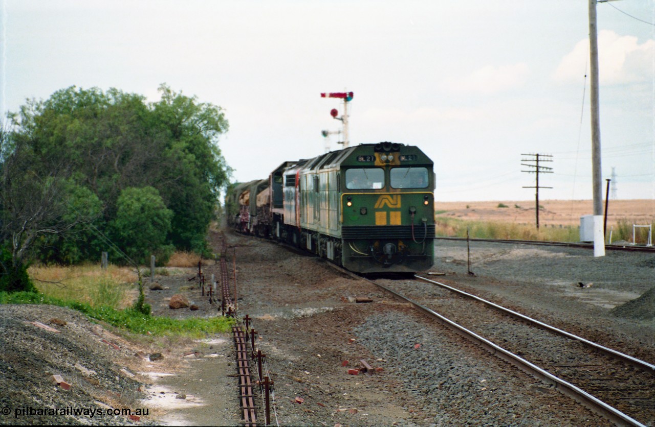 159-11
Gheringhap, track view looking east towards Geelong from the former No.2 platform, signal rodding running along edge of platform, Australian National broad gauge BL class BL 27 Clyde Engineering EMD model JT26C-2SS serial 83-1011 leads sister BL class and a V/Line S class and X class locomotives with down goods train 9169 as it arrives on their way to Adelaide.
Keywords: BL-class;BL27;Clyde-Engineering-Rosewater-SA;EMD;JT26C-2SS;83-1011;