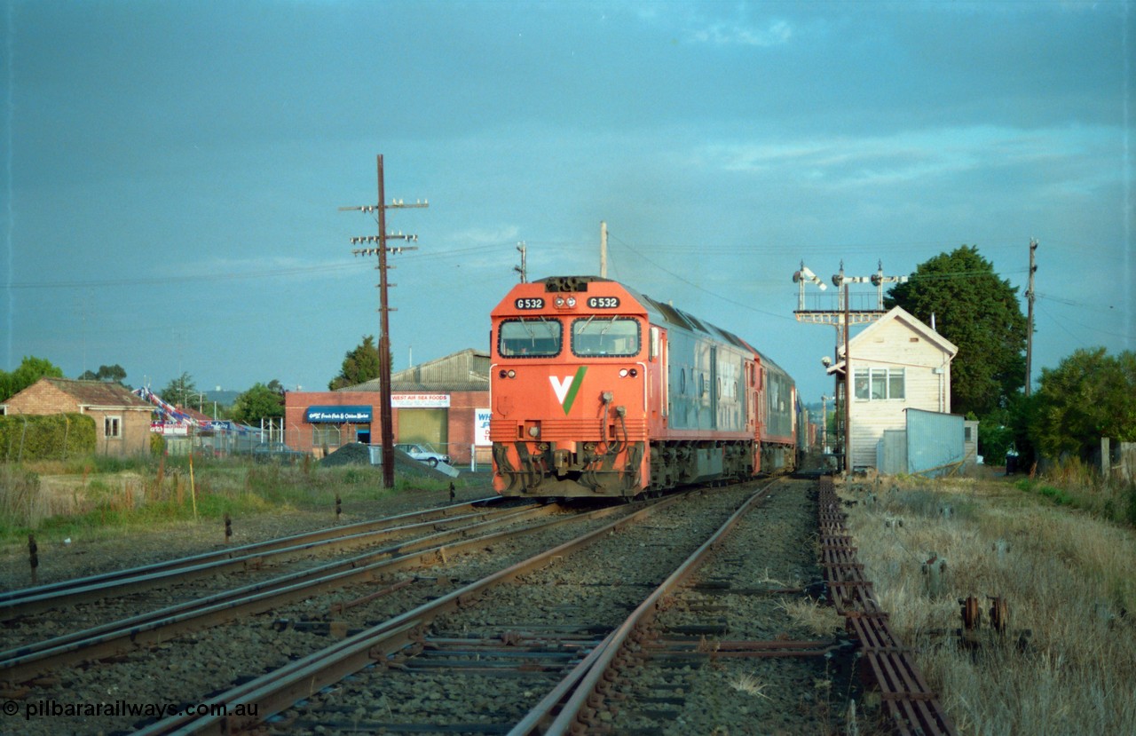 159-21
Ballarat D Signal Box, Linton Junction, V/Line broad gauge G class G 532 Clyde Engineering EMD model JT26C-2SS serial 88-1262 leads a sister with a down Adelaide bound goods train across Gillies Street triple doll semaphore signal post 20 is pulled off for the Ararat line as the train swings off the down line which becomes the Linton line, with the Cattle Yard line points just visible, points and track work, interlocking and point rodding.
Keywords: G-class;G532;Clyde-Engineering-Somerton-Victoria;EMD;JT26C-2SS;88-1262;