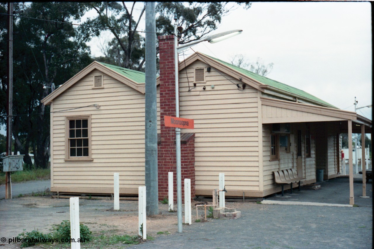 160-13
Mooroopna, platform view of the station building, shows fire place chimney and the various service connections to the building.
