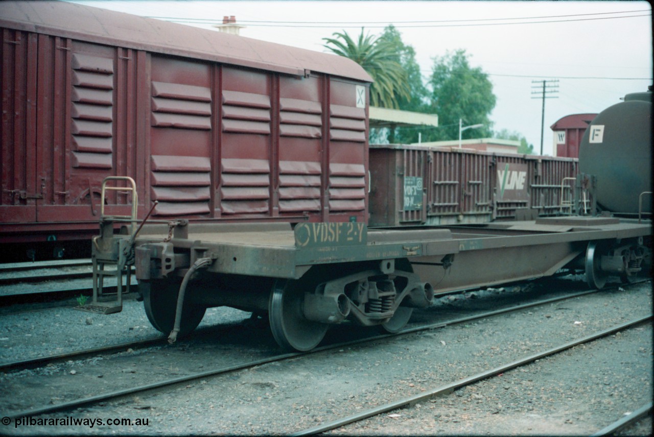 160-23
Shepparton, V/Line broad gauge VDSF type bogie safety waggon VDSF 2, started life as a Flexi-Van transport waggon FV 2 built by South Australian Railways' Islington Workshops in July 1961, then became FVF in 1962 on standard gauge, in the 1980s back to broad gauge and coded VQAY, VDSY and became VSDF in 1988, hand brake end showing ratchet style hand brake.
Keywords: VDSF-type;VDSF2;SAR-Islington-WS;FV-type;