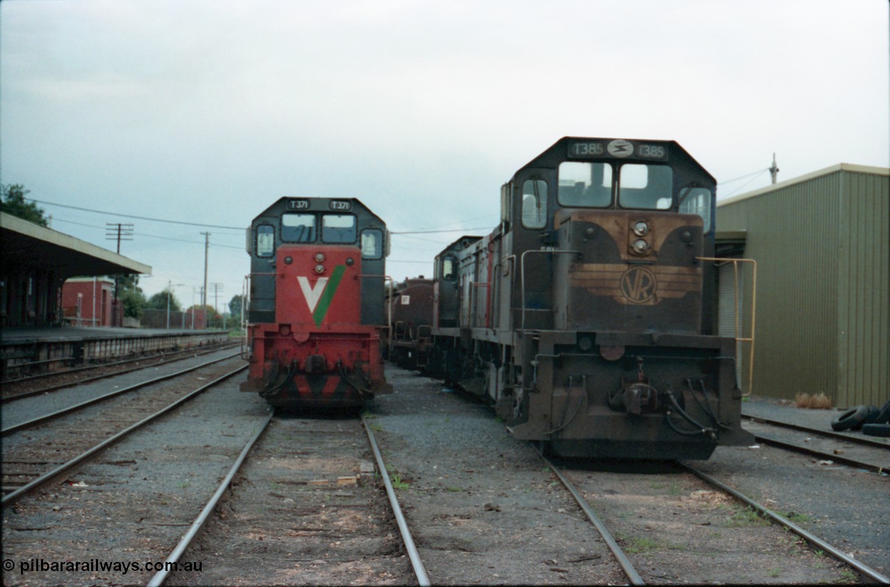 160-26
Shepparton, yard view of stabled broad gauge V/Line T class locomotives T 371 Clyde Engineering EMD model G8B serial 64-326 and T 385 serial 64-340 still in Victorian Railways blue and yellow livery, goods shed on the right, station platform and building on the left, T class T 393 serial 65-423 is behind T 385.
Keywords: T-class;T371;Clyde-Engineering-Granville-NSW;EMD;G8B;64-326;