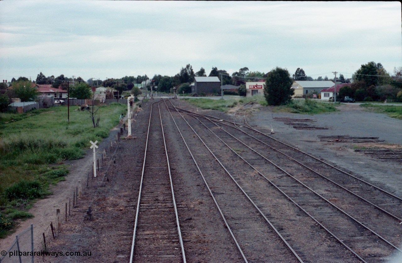 161-02
Numurkah, station yard overview looking north towards Picola Junction, steam era stand pipe remains on No.1 Rd, semaphore signal post remains with Picola Line doll removed, the down starting semaphore for the Strathmerton line is visible in the trees, track to turntable and ash pit at right.
