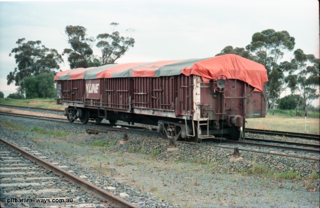 161-13
Katunga, north end of yard view with derailed V/Line broad gauge VOFX type bogie open waggon VOFX 1044 covered with tarpaulin and loaded with super phosphate, hand brake end, waggon started life built by Victorian Railways Bendigo Workshops in May 1975 as an ELX type, in 1978 to VOCX and in the 1980s to VOFX, point rodding for derail and derail visible under middle of waggon, mainline behind waggon.
Keywords: VOFX-type;VOFX1044;Victorian-Railways-Bendigo-WS;ELX-type;
