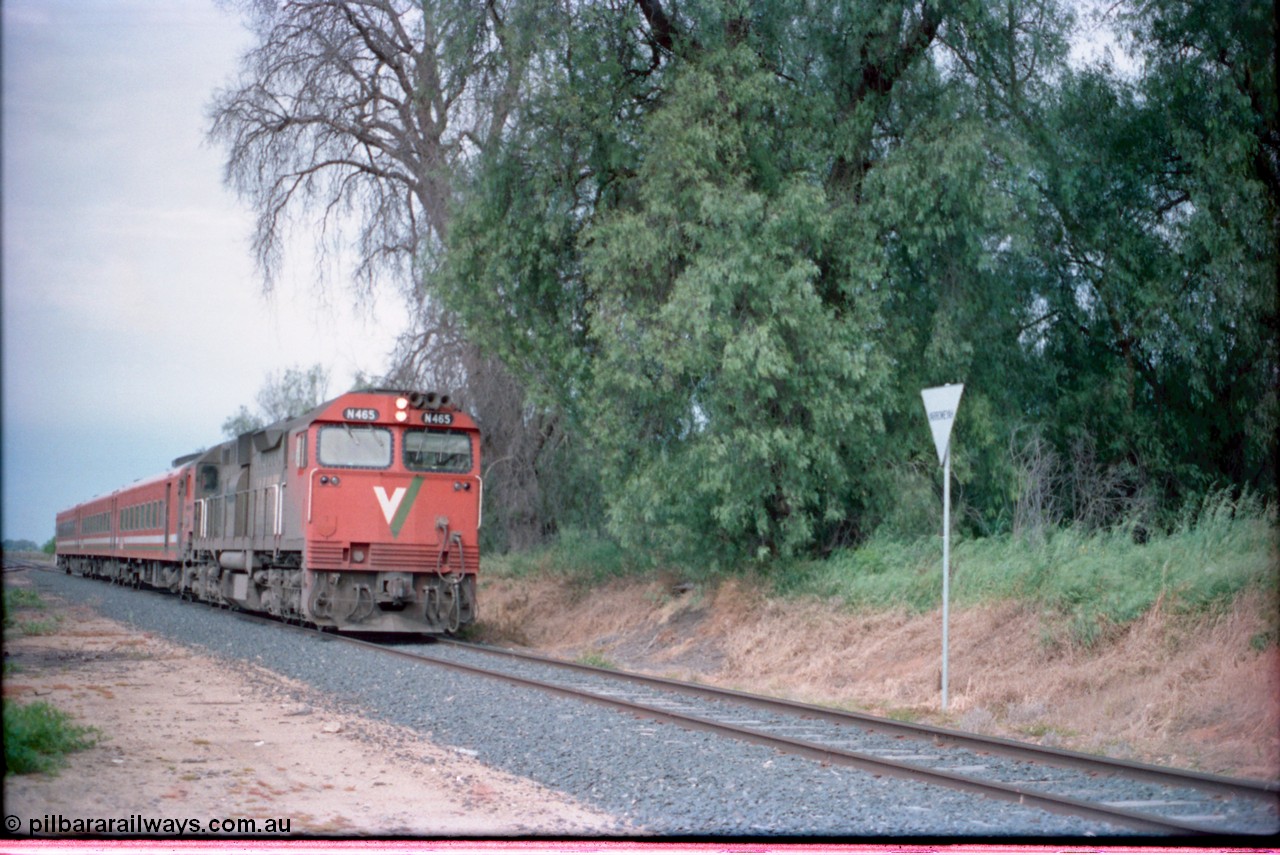 161-17
Yarroweyah, V/Line up broad gauge Cobram passenger train hauled by N class locomotive N 465 'City of Ballaarat' Clyde Engineering EMD model JT22HC-2 serial 86-1194 and N set past overgrown former station site, yard behind.
Keywords: N-class;N465;Clyde-Engineering-Somerton-Victoria;EMD;JT22HC-2;86-1194;