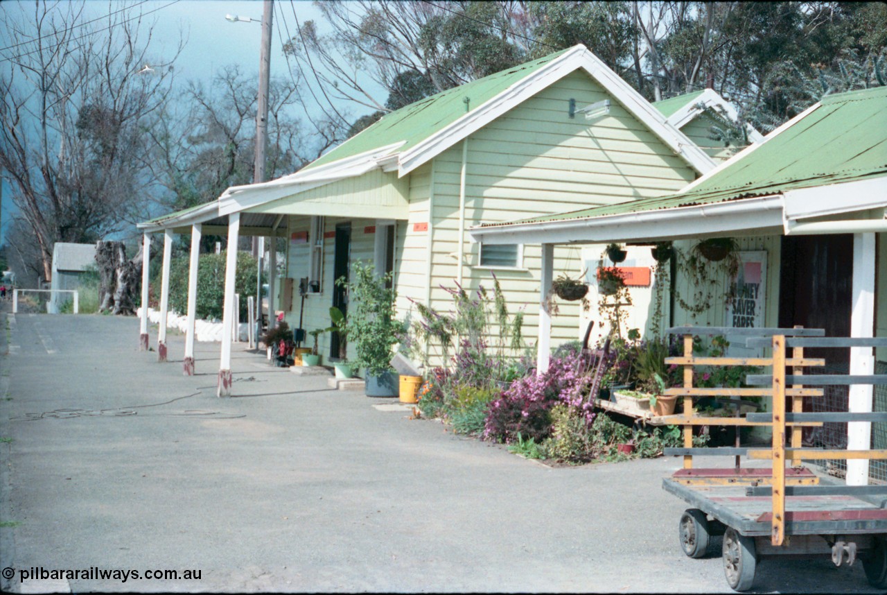 161-20
Cobram, station platform and building overview, show well maintained garden, luggage trolley, the way we were.
