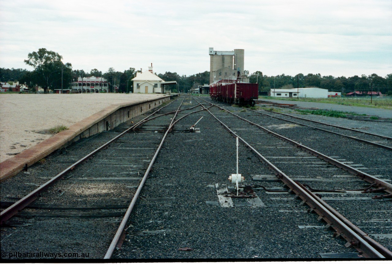 161-30
Tocumwal, broad gauge station yard overview looking south from end of platform, track and points and levers, station building and sleeper transport waggons, a hotel and flour mill in the background.
