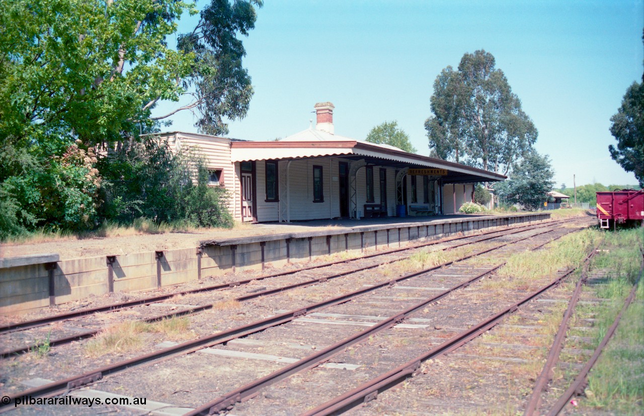 162-1-11
Healesville, station yard view looking south, station building and platform, yard overview, freshly repainted GY type four wheel waggon in yard.
