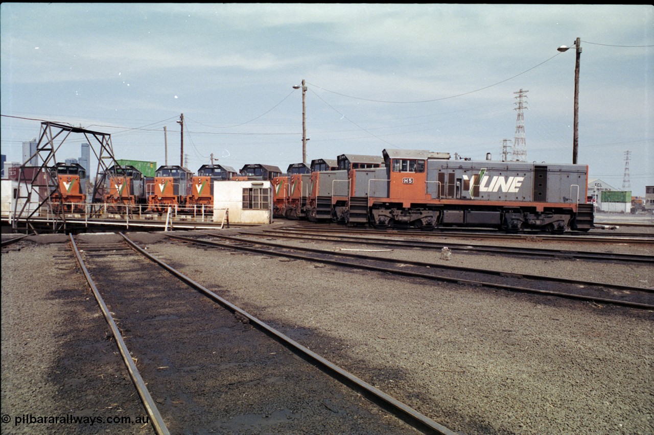 162-2-21
South Dynon Motive Power Depot, broad gauge turntable and radial roads, V/Line diesel electric locomotives of the T and H classes line the roads, H class H 5 Clyde Engineering EMD model G18B serial 68-632.
Keywords: H-class;H5;Clyde-Engineering-Granville-NSW;EMD;G18B;68-632;