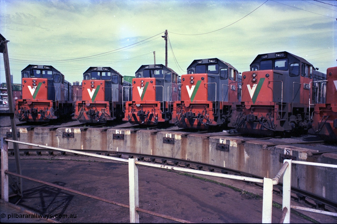 162-3-01
South Dynon Motive Power Depot, broad gauge turntable radial roads, V/Line diesel electric locomotives T class T 386 Clyde Engineering EMD model G8B serial 64-341, T 387 serial 65-417, T 401 Clyde Engineering EMD model G18B serial 67-496, T 402 serial 67-497 and T 405 serial 67-500, PTC Open Day.
Keywords: T-class;T386;Clyde-Engineering-Granville-NSW;EMD;G8B;64-341;